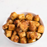 Photo of a bowl of cubed fried tofu